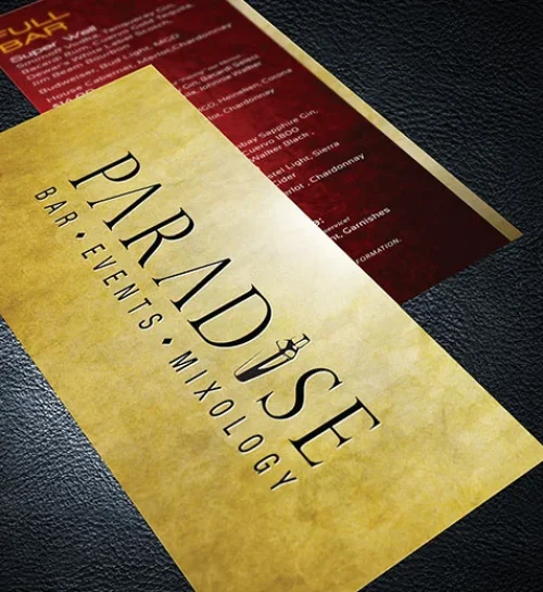 Elegant gold and black business card featuring the word "Paradise," designed by Dogs of Design for a beverage service