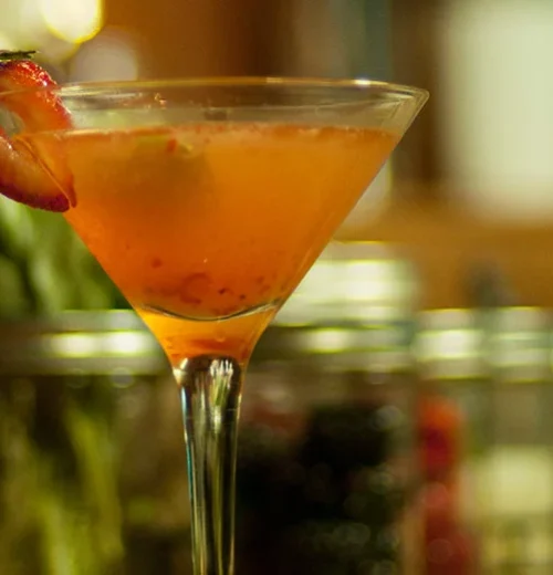 A fresh strawberry adorns a martini, adding a pop of color and charm at Paradise Bar and Beverage Service