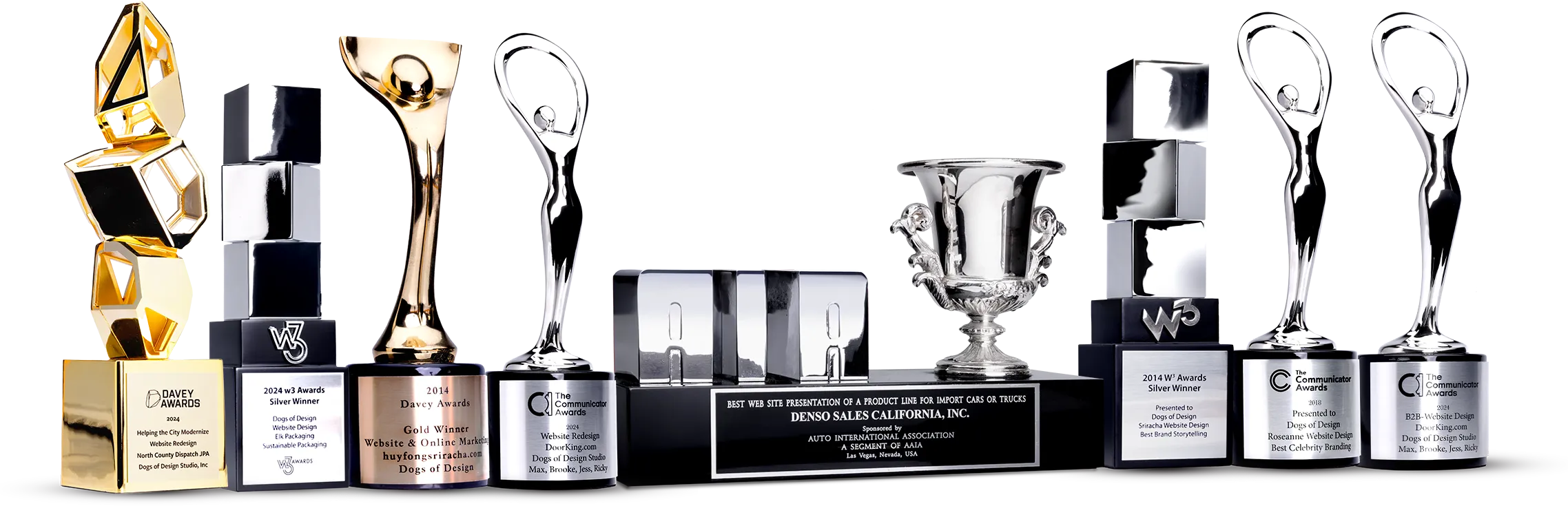 Trophy lineup showcasing Dogs of Design’s industry awards for web, branding, and packaging design